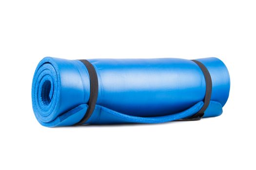 Blue rolled yoga mat for exercise, isolated on white background.