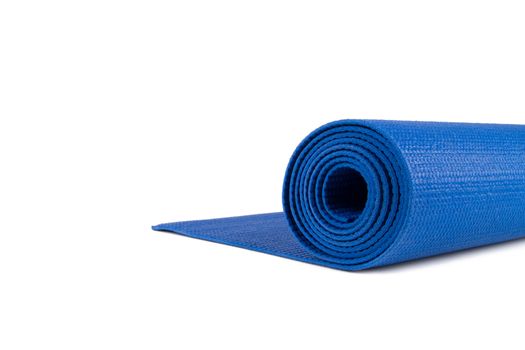 Close up view of blue rolled yoga or pilates mat for exercise, isolated on white background.