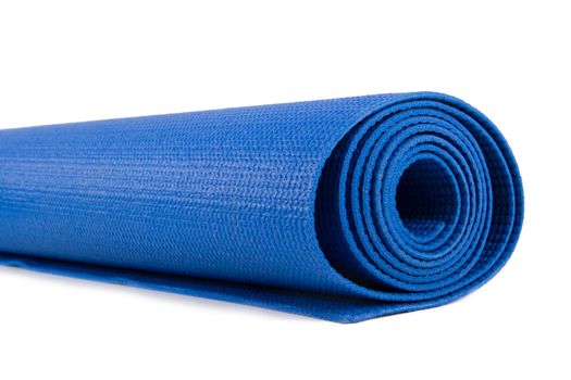 Part of blue rolled yoga or pilates mat for exercise, isolated on white background.