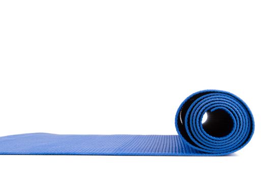 Side view of blue open yoga mat for exercise, isolated on white background.