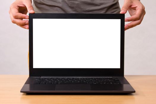 new black laptop on table with mans hand