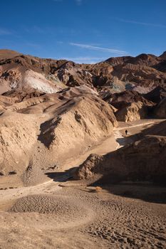 Hiker comes down a wash in Death Valley