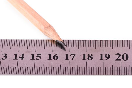 Close up view of wood pencil and steel ruler for engineering drawing, isolated on white background.