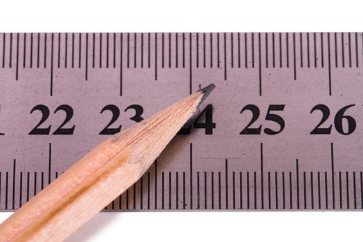 Close up view of wood pencil and steel ruler for engineering drawing, isolated on white background.