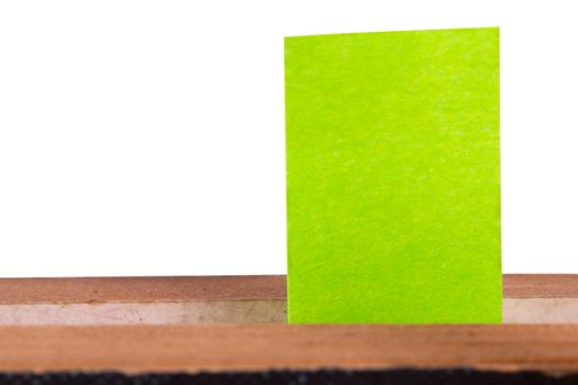 Green post it marker inside book, front view, isolated on white background.