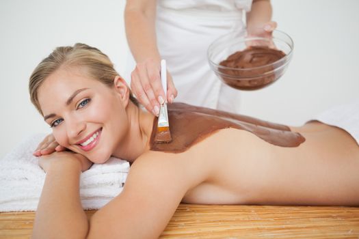 Beautiful blonde enjoying a chocolate beauty treatment at the health spa