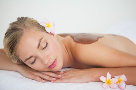 Beautiful blonde enjoying a chocolate beauty treatment at the health spa