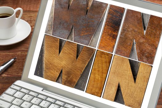 win-win - negotiation or conflict resolution strategy  -  words in letterpress wood type on a laptop screen with a cup of coffee