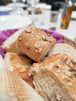 bread with seed and cereals sliced in basket at table