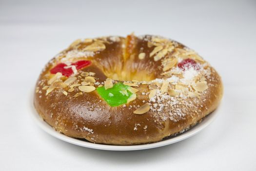 typical spanish circular cupcake with candied fruit named roscon or three kings cake