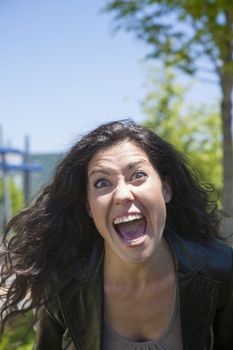 angry woman shouting to camera at exterior background