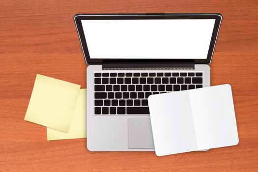 Top view of laptop mock up and yellow sticky posts and white, blank note book on modern, wooden office table.