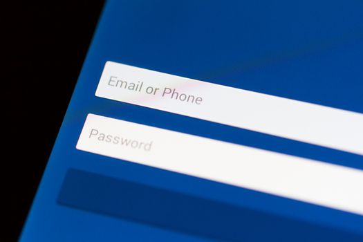 Email, phone and password login form on tablet with blue background.