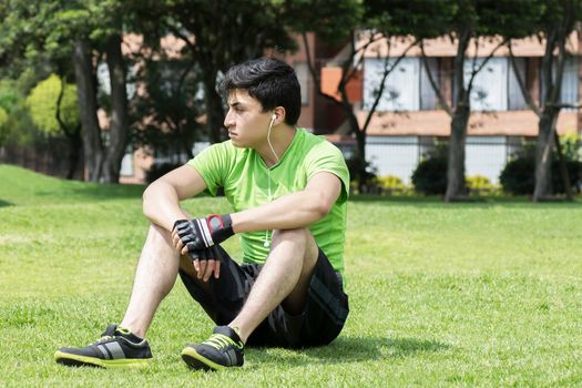 Young man at a local park taking a break of fitness workout