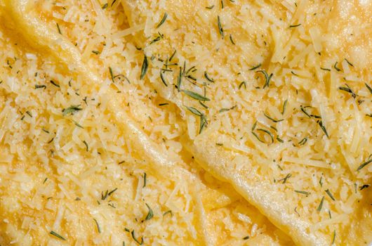 Delicious breakfast dish of omelette with parmesan cheese and thyme, overhead view