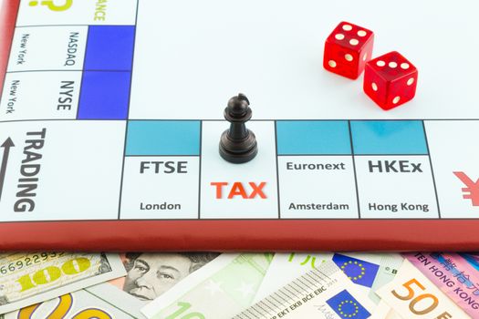 money background and stock exchange board game with red dices and black piece places on tax area