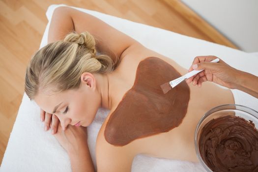 Beautiful blonde enjoying a chocolate beauty treatment at the health spa