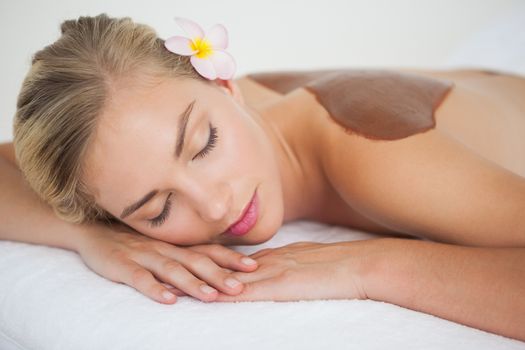 Beautiful blonde enjoying a chocolate beauty treatment at the health spa