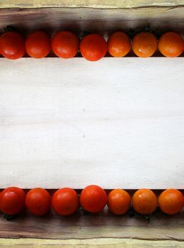 cherry tomatoes on wood - grunge frame
