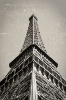 The Eiffel Tower in Paris, France. Vintage look: monochrome with sepia toning, scratches and film grain
