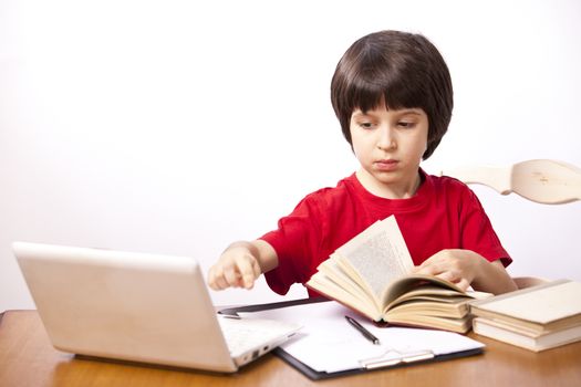 serious boy with a book and a netbook