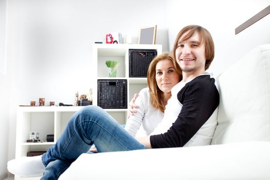 Happy couple relaxing in living room