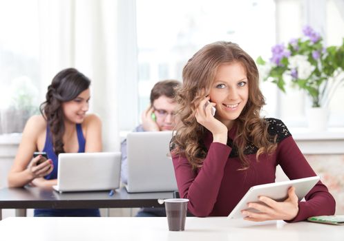 smiling student with smartphone talking 