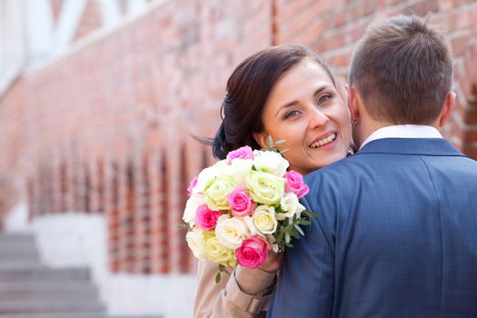 bride with bouquet and groom