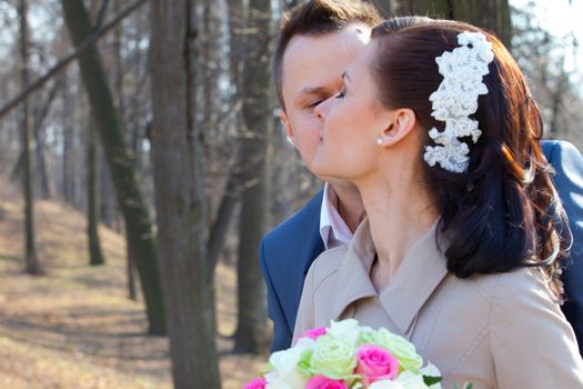 bride and groom on a park background