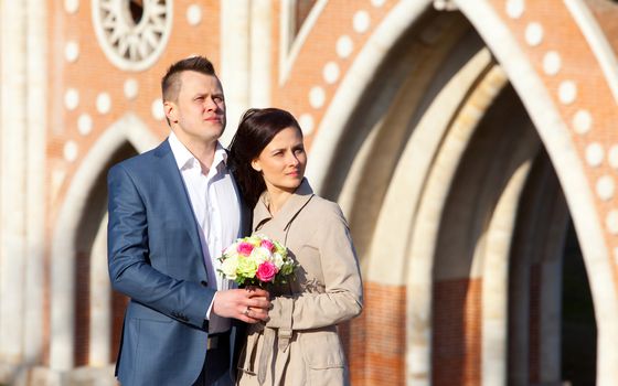 bride and groom on a architectura vintage background