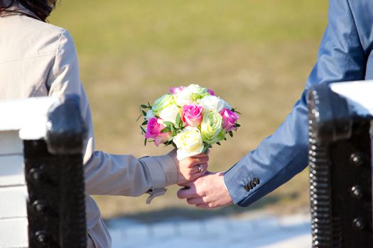 Wedding couple holding a bouquet