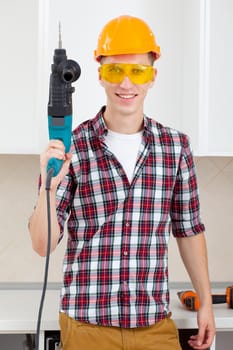 worker in protective orange helmet and eyeglasses with perforator