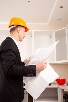 engineer with blueprints in the interior of the new office