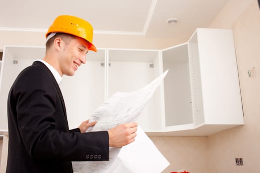 Engineer with documents in the interior of a new home or office