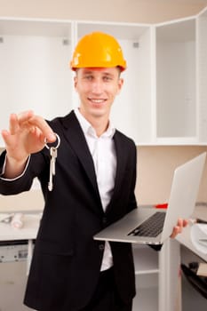 Smiling civil engineer showing apartment  keys