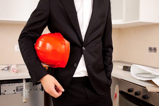 engineer or businessman  holding a helmet under his arm 