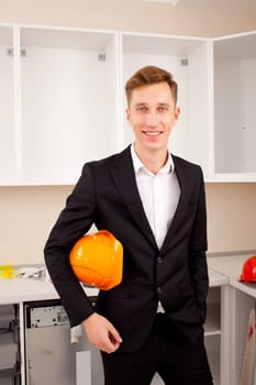 engineer in the new interior, with protective helmet under his arm