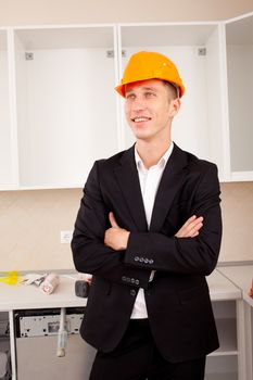 smiling engineer in the interior of a new apartment