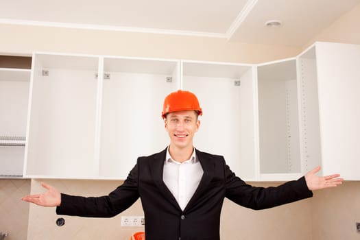 smiling civil engineer shows new apartment after renovation