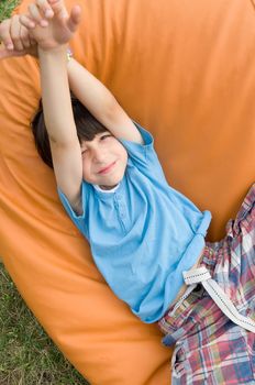 young smiling boy stretching arms