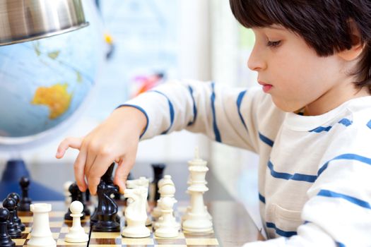 boy playing a game of chess, the development of logical thinking