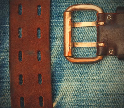 vintage leather belt on the denim background. instagram image style