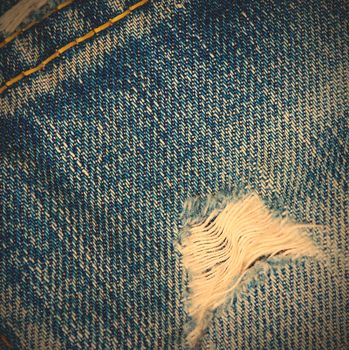 frayed blue jeans background, close up. instagram image style