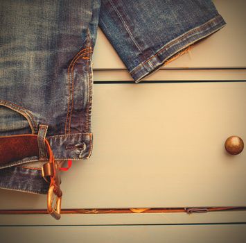 Jeans hanging from a drawer
