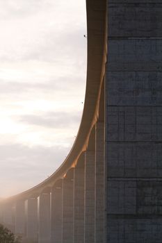 Large highway viaduct with foggy sunrise on autumn