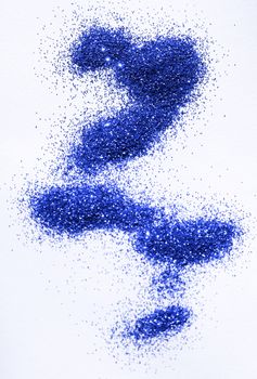 Blue glitter on light background - macro photo