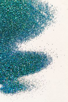 Turquoise glitter on light background - macro photo