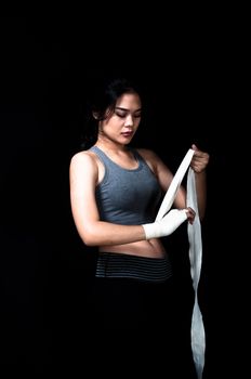 Asian female boxer on black background