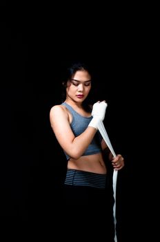 Asian female boxer on black background