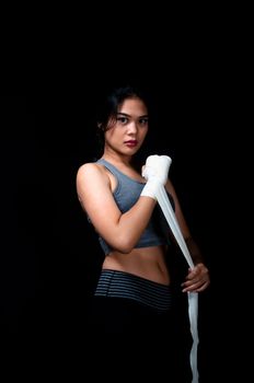 Asian female boxer on black background